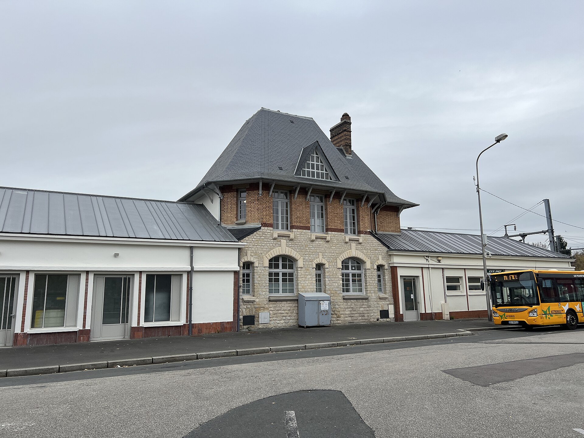 L'aile ancienne de la gare de Lisieux et un bus à l'arrêt